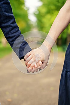 daughter and mother, friends, holding each other's hands in the park on a warm sunny day Mother or friendship day