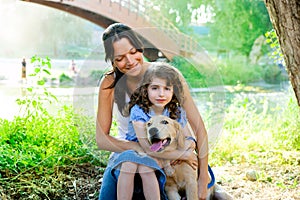 Daughter and mother with golden retriever