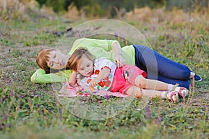 Daughter and mother lying on the grass