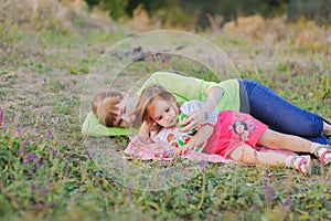 Daughter and mother lying on the grass