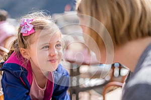 Daughter and mother talking in a restaurant