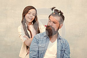 Daughter playing with hair. Ideas to entertain kids during quarantine. Family leisure concept. Girl dad hairdo