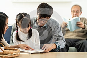 Daughter reading story with multigenerational family