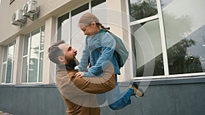 Daughter run to father hug lift pick up happy family meeting child offspring little girl schoolgirl elementary school