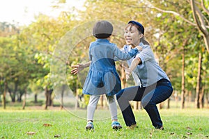 Daughter running to hug mother in the garden