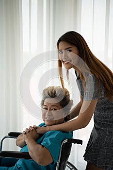 Daughter of a senior patient taking care and encouraging the mother