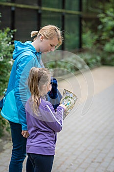 Daughter showing her mum directions on the map