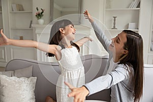 Daughter stretching raised hands rush to get into moms hugs