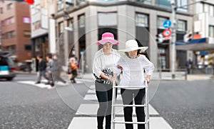 Daughter take care elderly walking across the street