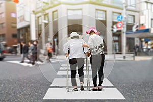 Daughter take care elderly woman walking across street