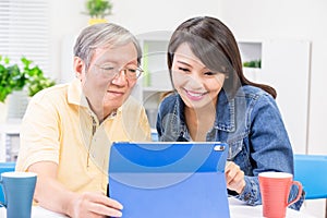 Daughter teach father use tablet