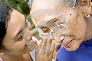 Daughter tell a secret to her old mother