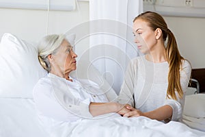 Daughter visiting her senior mother at hospital