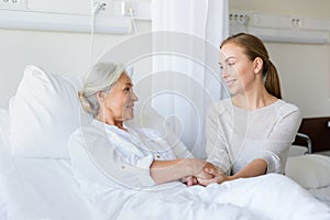 Daughter visiting senior mother at hospital