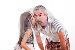 Daughter whispering secret in dad's ear