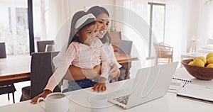 Daughter and working mother, single parent or small business entrepreneur typing on a laptop, pointing at the screen