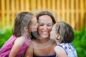 Daughters Kissing their Mother