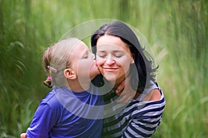 The daugther kisses her mother