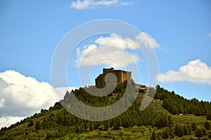 Davalillo Castle on top of the mountain with cloudy blue sky.