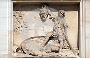 David with the Head of Goliath, marble relief on the facade of the Milan Cathedral, Duomo di Santa Maria Nascente, Milan, Italy