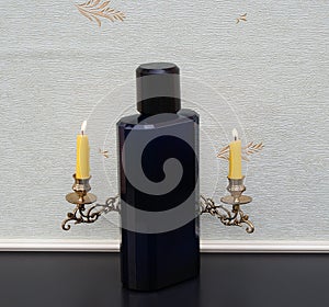 Davidoff Cool Water large perfume bottle in front of a piano candelabra with shining candles