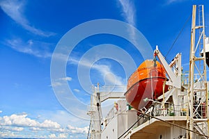 Davit lifeboat, Rescue boat or lifeboat of Cargo ship on blue sky background. photo