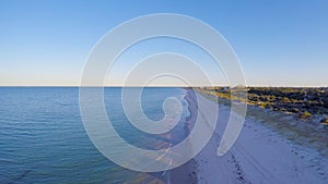 Dawn aerial view of South Australian beach with sun rising over Adelaide