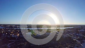 Dawn aerial view of South Australian beach with sun rising over Adelaide