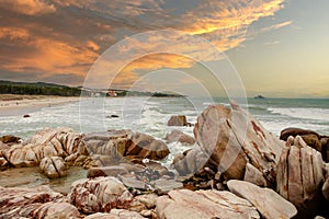 Dawn on beautiful beaches with white sand streaks waves like silk to create many beautiful shapes on the beach has many rocks