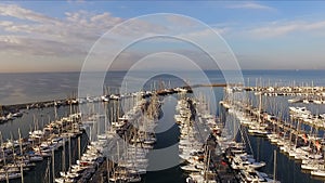 Dawn in the Greek marina, Athens. Aero video shooting. A lot of different yachts, catamarans moored to piers. In the