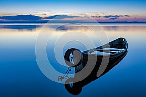 Dawn on lake Seliger with an old fishing boat in the foreground