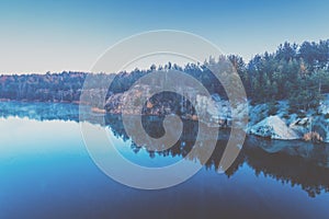 Dawn over the lake with the rocky shore