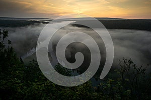 Dawn over the river in the fog