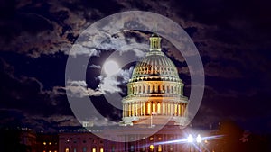 Dawn over Washington DC US Capitol Building in night sky with full moon