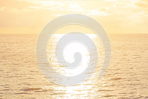 Dawn sea concept: Sun light and blur beach sunset texture background