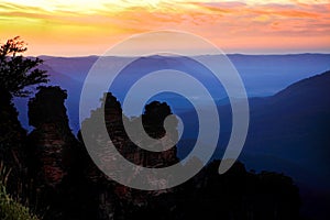 Dawn sunrise silhouettes the Three Sisters Blue Mountains Australia photo