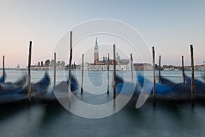 Dawn in Venice with gondolas and mooring posts