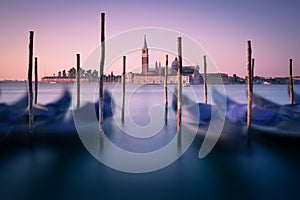 Dawn in Venice with gondolas and mooring posts