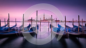 Dawn in Venice with gondolas and mooring posts