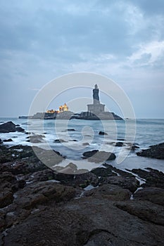 Dawn view of the sea from sea shore with statue