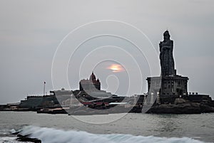 Dawn view of the sea from sea shore with statue