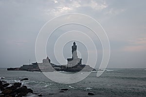 Dawn view of the sea from sea shore with statue