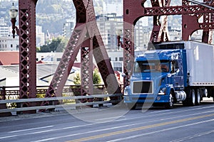 Day cab blue big rig semi truck transporting commercial cargo in