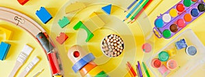 Day care concept - art supplies and toys on bright background