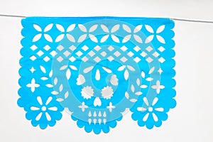 Day of the Dead, Papel Picado with a skull head, blue traditional Mexican paper cutting flag.