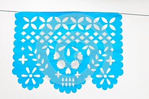 Day of the Dead, Papel Picado with a skull head, blue traditional Mexican paper cutting flag. photo