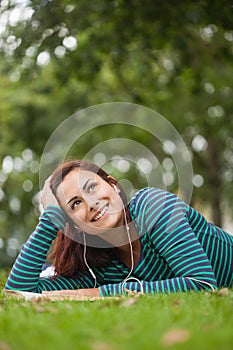 Day dreaming casual student lying on grass looking up