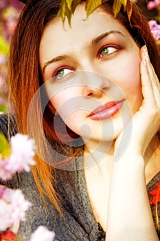 Day dreaming pensive woman and spring flowers