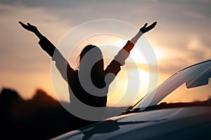 Silhouette of Happy Female Driver Next to her Car