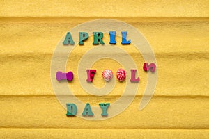 Day of the Fool Day, inscription from multi-colored letters on a yellow paper background